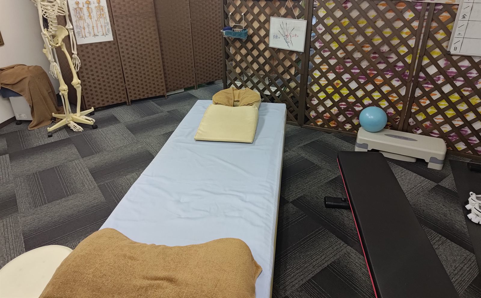 施術ベッドと運動器具のある部屋